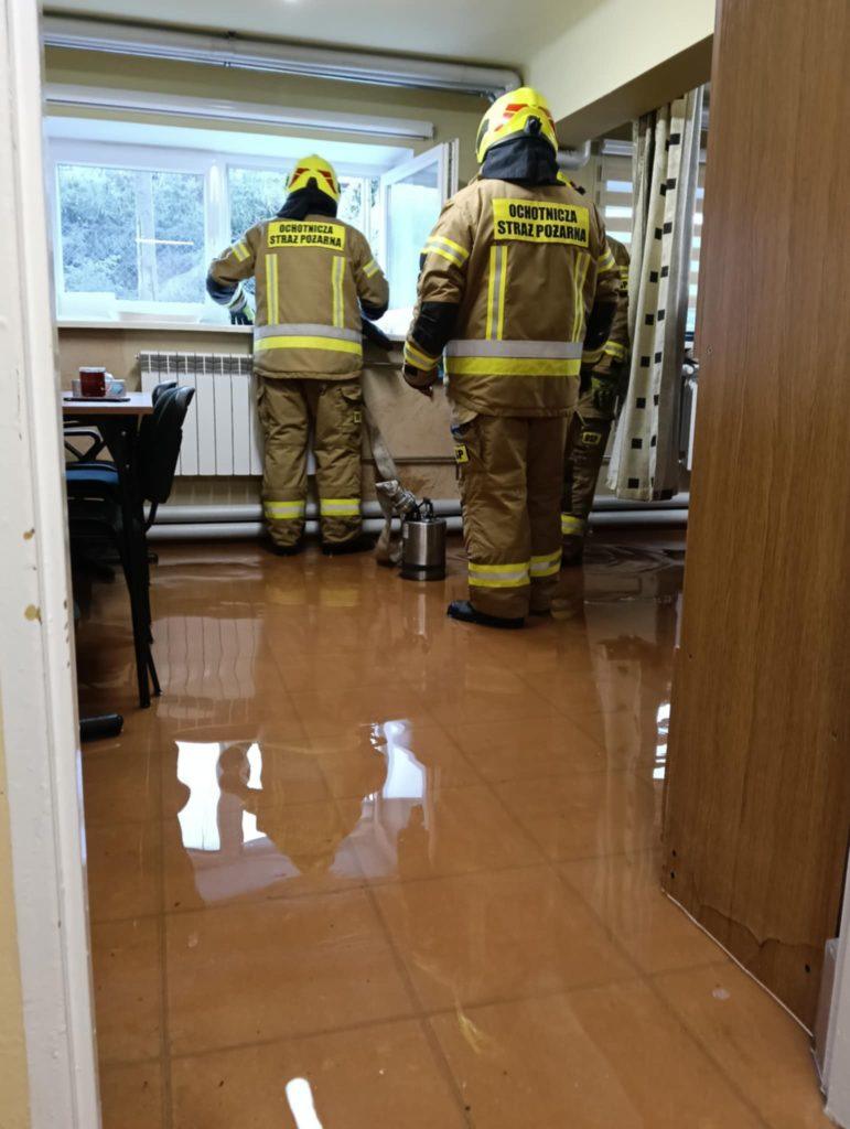woda na posadzce zalanej szkoły, strażacy